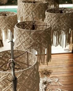 macrame baskets are hanging from the ceiling in front of a pool and deck