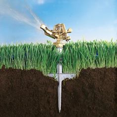 a sprinkler watering grass in the ground