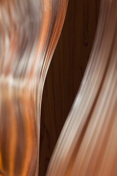 blurry photograph of an orange and white object in the foreground with wood background