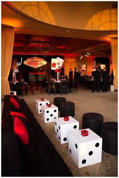 dices are lined up on the floor in front of tables and chairs at a party