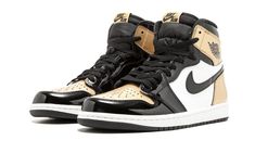 Not to be confused with the “Gold Top Three” colorway, the Air Jordan 1 High OG released in a second white, black, and gold patent leather combination in 2018 for the NBA All-Star Weekend festivities.  The “Gold Toe” Air Jordan 1 features—you guessed it—gold color blocking on the toe panels, while a “Black Toe”-style colorblock is found on each lateral side and a “Bred”-style block is on each medial side.  You just can’t go wrong with a gold pair of Air Jordan 1s.  The Air Jordan 1 Gold Toe is a must-have for any fan of the iconic silhouette. Enhypen Shoes, Jordan 1 Gold, Yeezy 750, Nike Air Jordan 1 High, Air Jordan 1s, Dr Shoes, J 1, Jordan 4s, Jordan 10