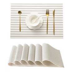 there is a place setting with silverware and napkins on the striped place mat