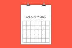 a calendar hanging on a wall with the word january in black and white, against an orange background