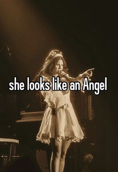 a woman standing on top of a stage with the words she looks like an angel