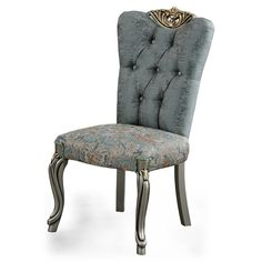 a chair that is upholstered with an ornate back and foot rests on a white background