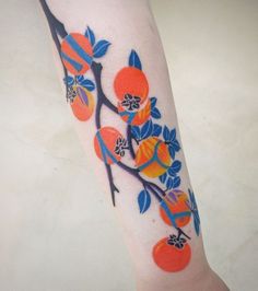 an orange tree branch with fruit on it's branches and leaves painted on the leg