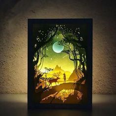 a paper cut artwork depicting a forest scene