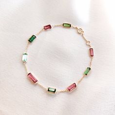 This stunning bracelet is set in 14k Solid Yellow Gold featuring Natural Multi Tourmaline Gemstone. It is an unique gemstone bracelet perfect for nearly every occasion and is completely hassle-free jewelry. ✓ Gem: Tourmaline ✓ Gem Size: (9 pcs) ✓ Gem Shape: Baguette ✓ Gem weight: 5.49 carats ✓ Gold purity: 14K ~ also available in 18K ✓ Gold weight: 1.75grams  ✓ Gross weight: 2.85grams The Gold purity is guaranteed and it comes with authentic 14K gold hallmark. Since these Bracelets are handmade, they are Nickel/Lead FREE.  ☑️CUSTOMISATION: * It can be made in 14KT/18KT white & rose gold as well. Kindly choose your preferred gold color from the drop-down option. * The same design can be made in varying lengths of your choice. * The same gemstone can be replaced by the one of your choice. I Baguette Bracelet, Diy Beaded Rings, Multi Gemstone Bracelet, Handmade Jewelry Box, Jewelry Making Bracelet, Diy Bracelet Designs, Tourmaline Bracelet, Unique Gemstones, Tourmaline Gemstone