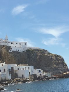 a white village on the side of a cliff