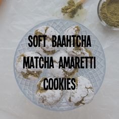 there is a plate with cookies and powdered sugar on it that says soft bahtcha matcha amarettii cookies