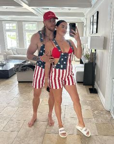 a man and woman in bathing suits taking a selfie with a cell phone while wearing american flag swimsuits