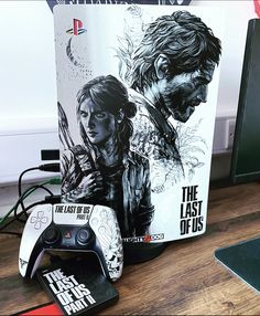 the last of us video game controller next to a box with the last of us on it