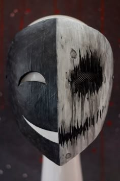 a black and white mask is on display