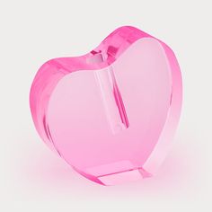 a pink heart shaped object on a white background