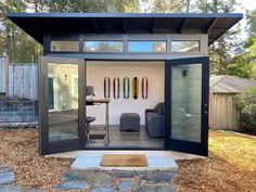 a small house with some surfboards on the wall