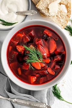 a white bowl filled with soup next to bread