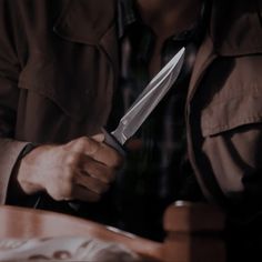 a man holding a knife in his right hand