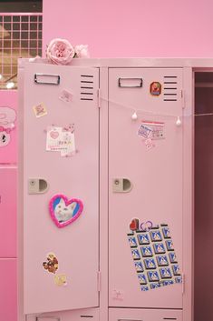 two pink lockers with stickers and magnets on them