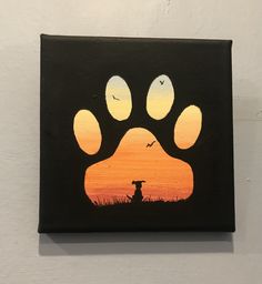 a painting of a dog's paw with the sunset in the background