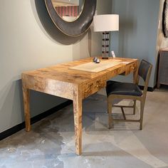 a wooden table sitting in front of a mirror