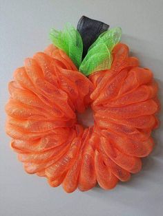 an orange mesh wreath hanging on the wall