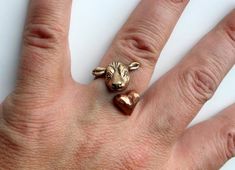 A lovely ring with a cow head in one end and a pink copper heart on the other. Nothing says I love cows quite as sweetly as this ring. Made in golden bronze, a heart in copper and a stainless steel ring band. Adjustable to fit any size. MADE ON DEMAND, takes me up to 7 workdays to complete.Other cow things: https://www.etsy.com/shop/AnnaSiivonen/search?search_query=Cow&order=date_desc&view_type=list&ref=shop_searchSimilar rings with other animals: https://www.etsy.com/shop/AnnaSiivon Cow Clothes, Cow Ring, Cow Things, I Love Cows, Cow Outfits, Mini Cows, Cowgirl Accessories, Jewelry King, Pink Copper