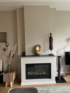 a living room filled with furniture and a flat screen tv on top of a fireplace