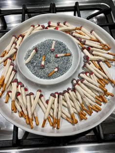 a white plate topped with lots of different types of matches on top of a stove