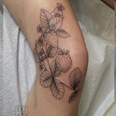 a black and white tattoo of strawberries on the leg