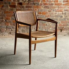 a chair sitting in front of a brick wall with no one on it's legs