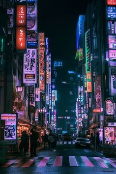 a city street filled with lots of neon signs