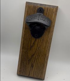 a wooden door handle with an iron finish on the front and back side, attached to a wood post