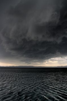 a large body of water under a cloudy sky