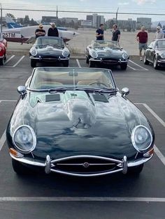 several classic cars are parked in a parking lot