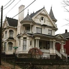 an old victorian style house with many windows