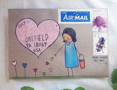 an airmail envelope with a drawing of a girl holding a bucket and a heart