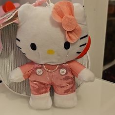 a hello kitty doll sitting on top of a table