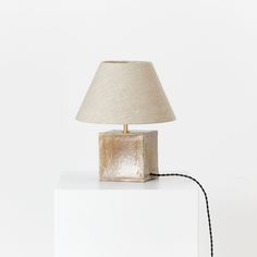 a lamp sitting on top of a white box