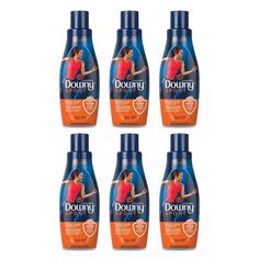 four bottles of downy women's body wash on a white background with blue caps