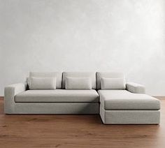 a white couch sitting on top of a wooden floor