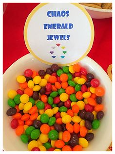 a bowl filled with lots of candy sitting on top of a table