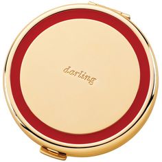 a red and gold plate with the word something on it's front side, sitting next to a white background