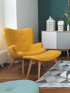 a living room with two chairs and a rug on the floor in front of it