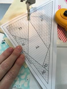 someone is working on their sewing project with scissors and tape measure the triangle to make it look like they are cutting