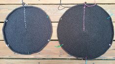 two round rugs with thread on them sitting next to each other in front of a wooden floor