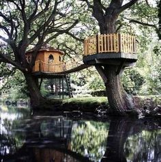 a tree house built on the side of a river