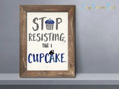 a wooden framed sign that says stop resisting, take a cupcake