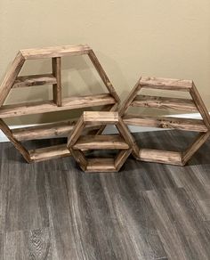 three wooden tables sitting on top of a hard wood floor