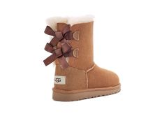 We added sweet silky bows to your little one's favorite boot, but kept the super-soft sheepskin feel they love. Built to move the way kids do, each boot features a rocker-bottom shape for a barefoot feel and our super-lightweight outsole for traction and durability.This product was made in a factory that supports women in our supply chain with the help of HERproject, a collaborative initiative that creates partnerships with brands like ours to empower and educate women in the workplace. | Protec Ugg Boots With Bows, Women In The Workplace, Ugg Bailey Bow, Kids Ugg Boots, Ugg Store, Bailey Bow Uggs, Bow Boots, Ugg Bailey, Bailey Bow