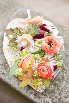 an arrangement of flowers is placed on a plate